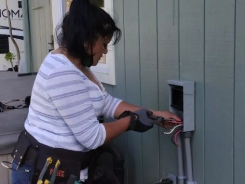 Licensed electrician wiring an exterior subpanel in Wasco